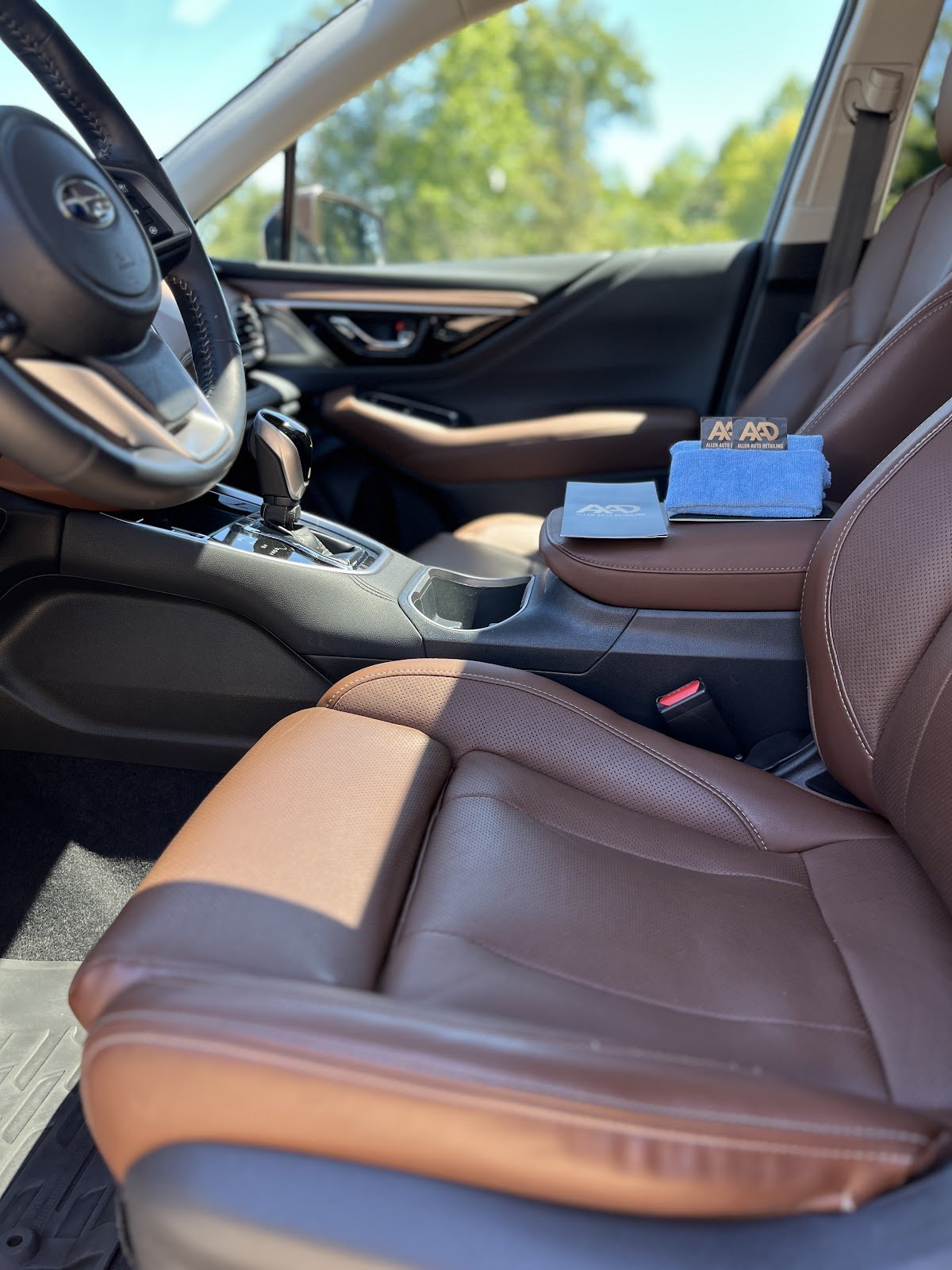 Clean brown leather seats and center console from Allen Auto Detailing’s Google photos