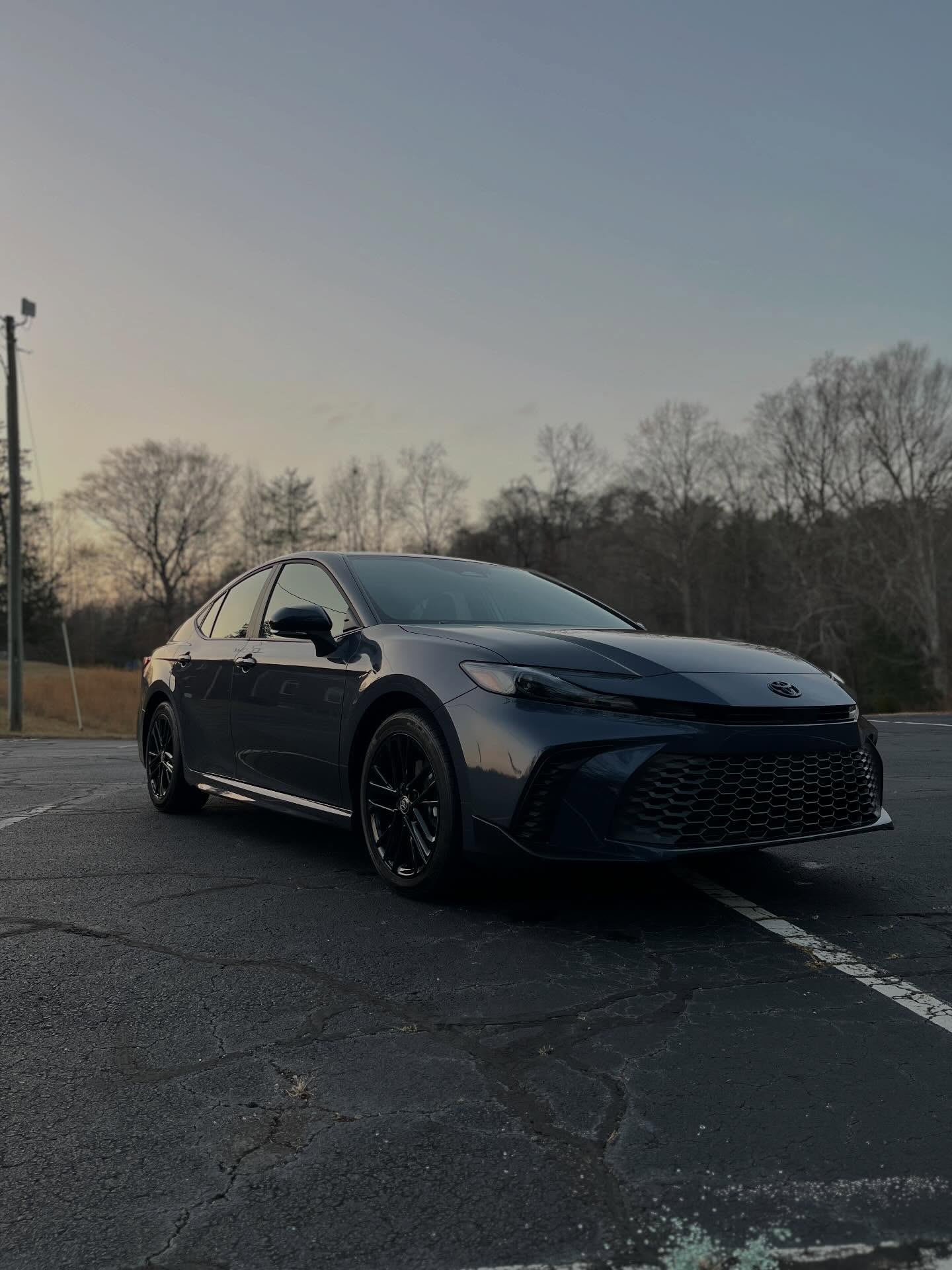 Dark grey Toyota Camry sedan with a clean, reflective finish